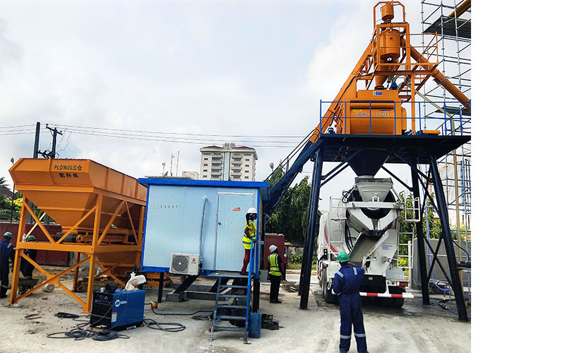 Engineers are maintaining a portable concrete batching plant in China.